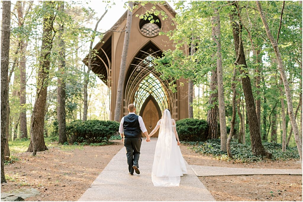 Josh and Prisca walking towards a cathedral during their Arkansas Elopement 
