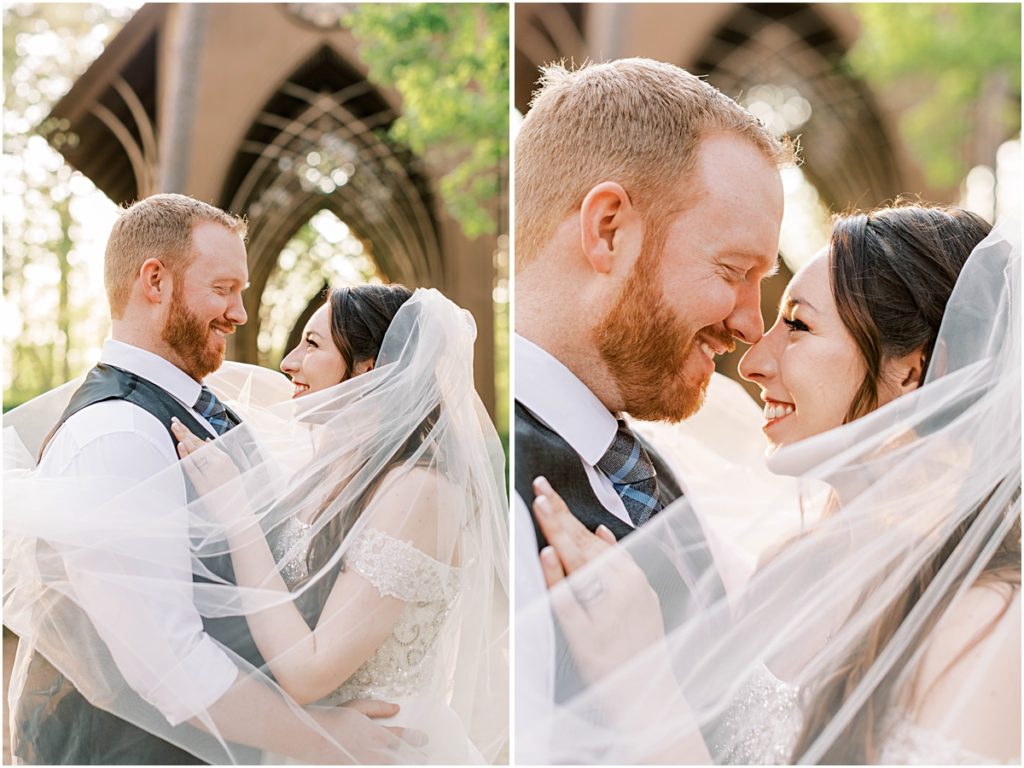 Josh and Prisca nuzzling wrapped in Prisca's veil during their Arkansas Elopement