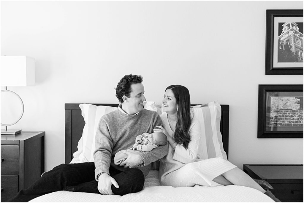 Mother and Father on bed, Father holding Baby James during Newborn Photography session