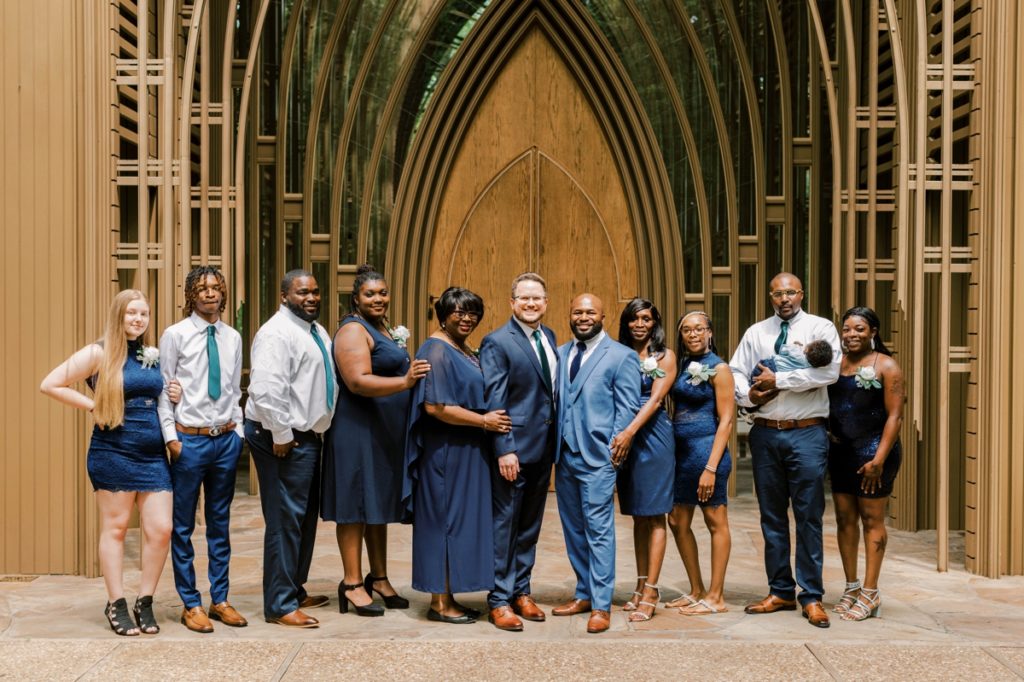 The grooms with their entire family in front of Cooper Chapel.