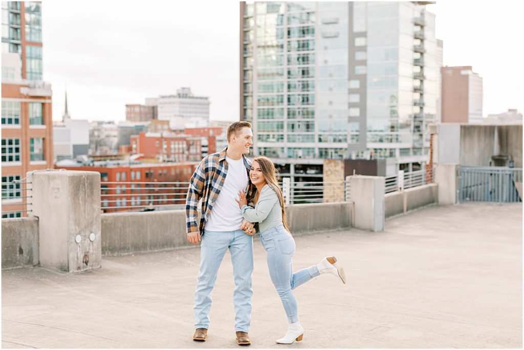 Madi leaning into Ty on parking garage rooftop, Pictures taken by Arkansas Photographer