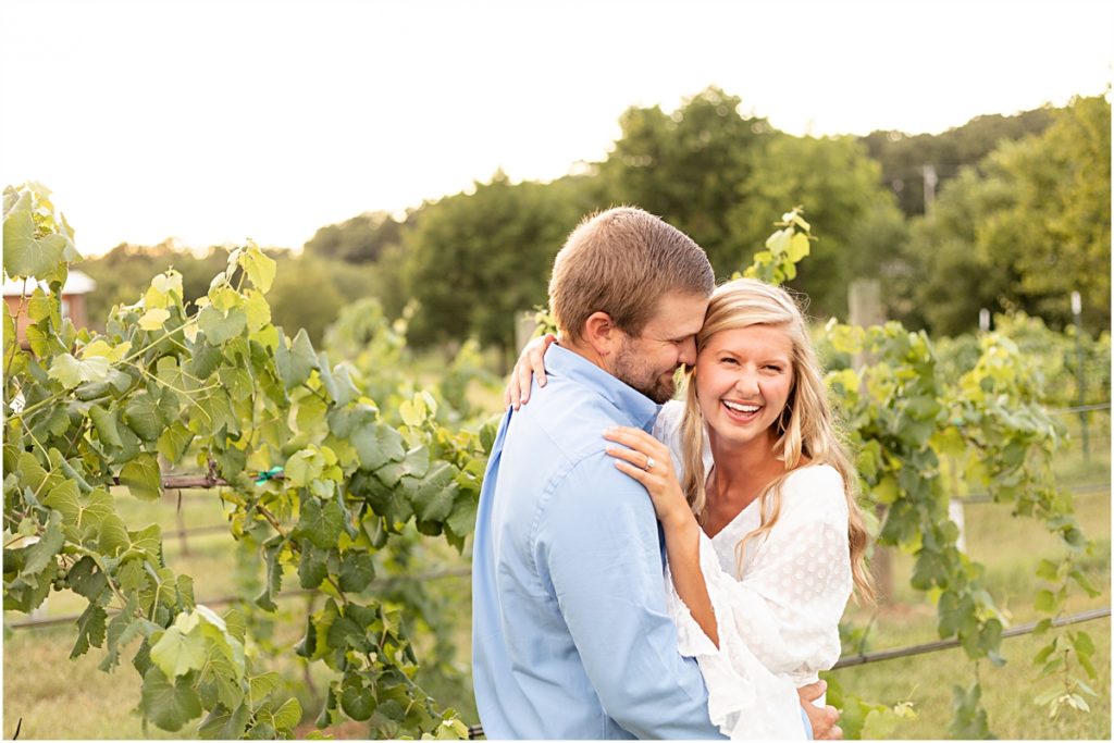 Remington and Jackson nuzzling during a Springdale AR Engagement session in the vineyard rows