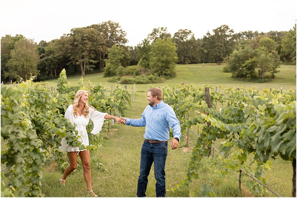 Remington and Jackson holding hands in the vineyard rows
