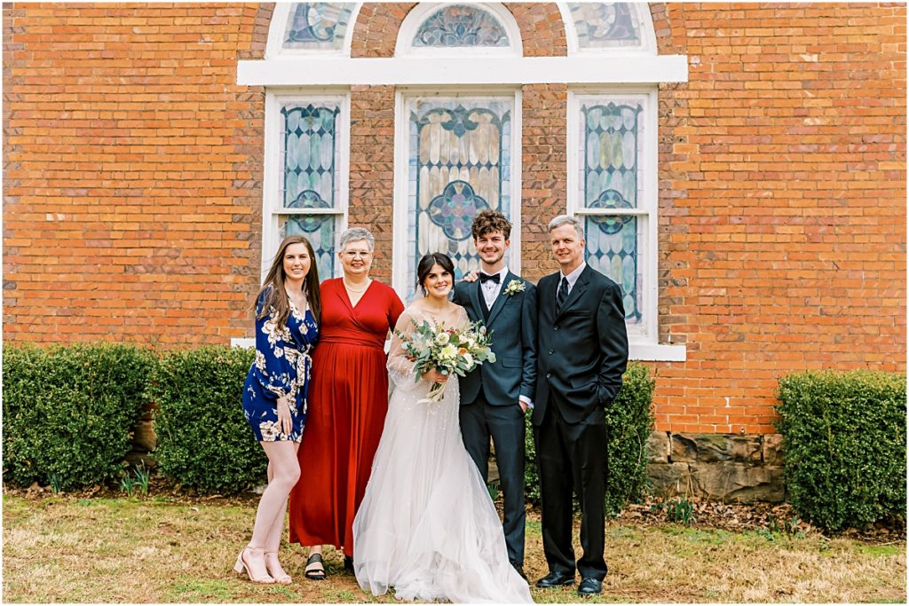 Emily and Lawrence with immediate family outside church during Arkansas Elopement 