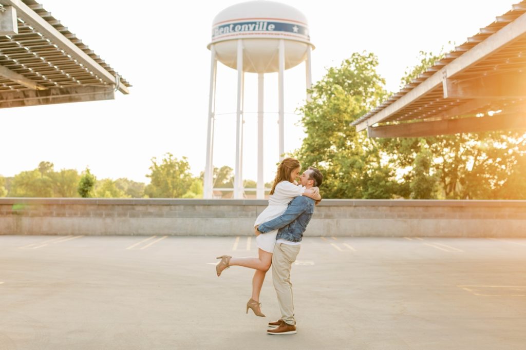 A man picks his fiance up and spins her around during their engagement session