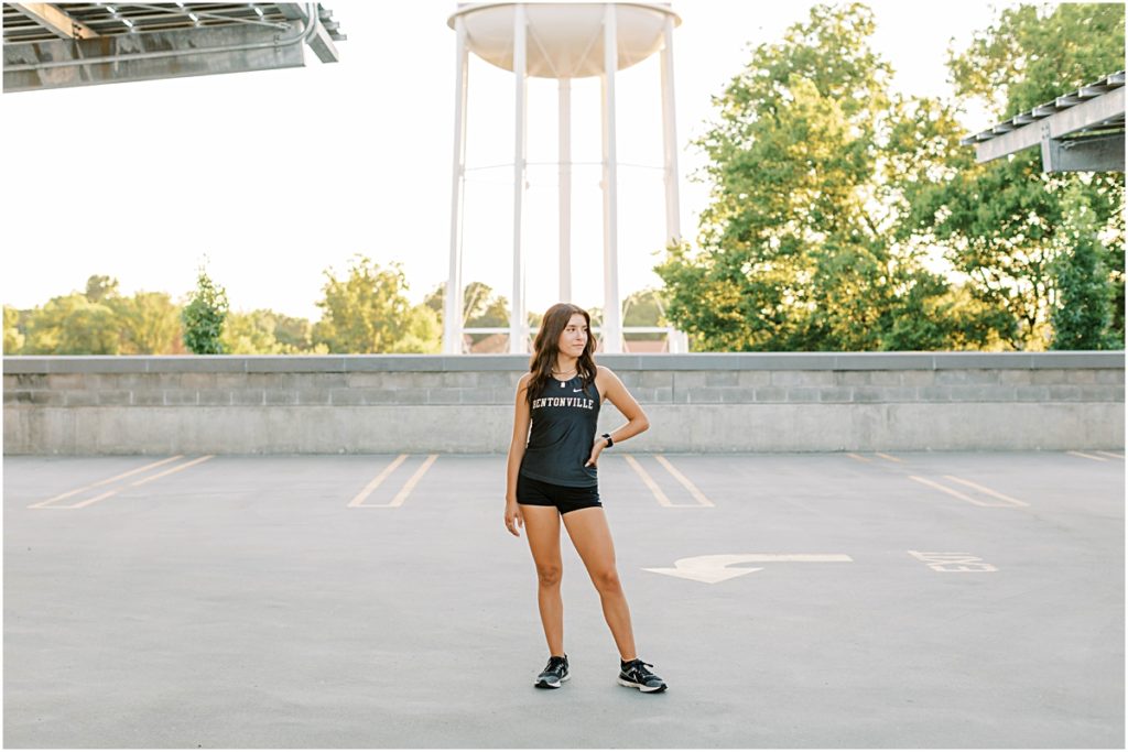 Madison standing in front of the Bentonville Water Tower. 