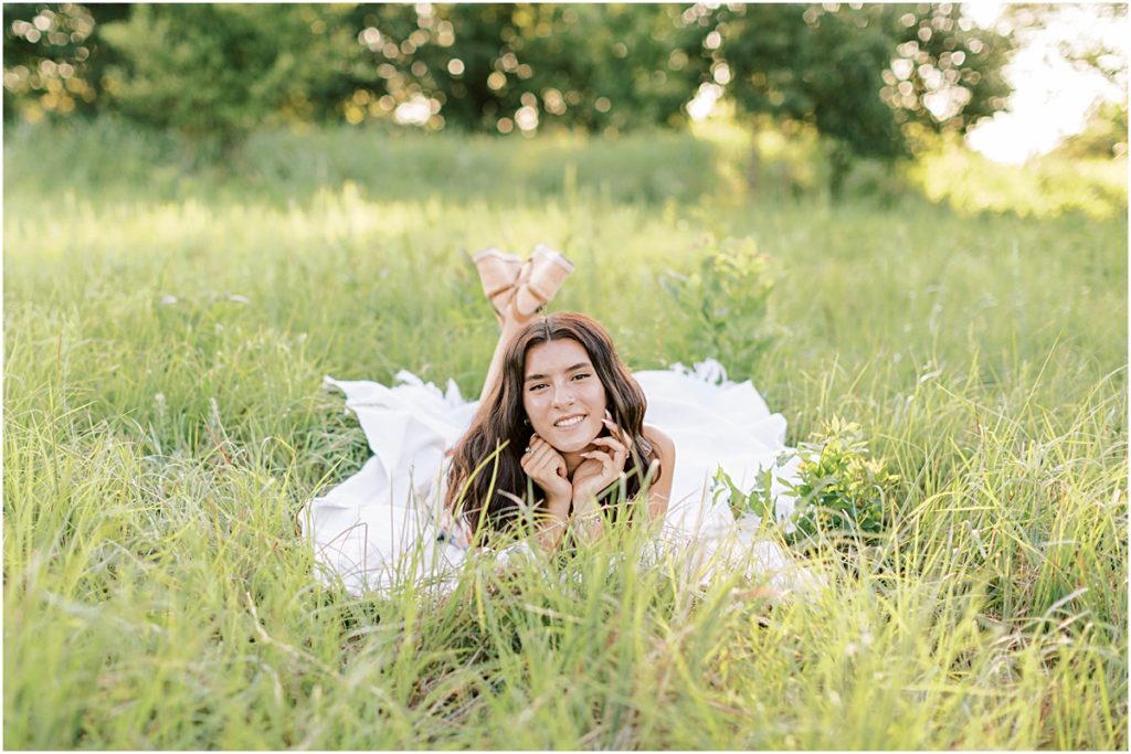 Wide Shot of Madison laying in a field on a blanket