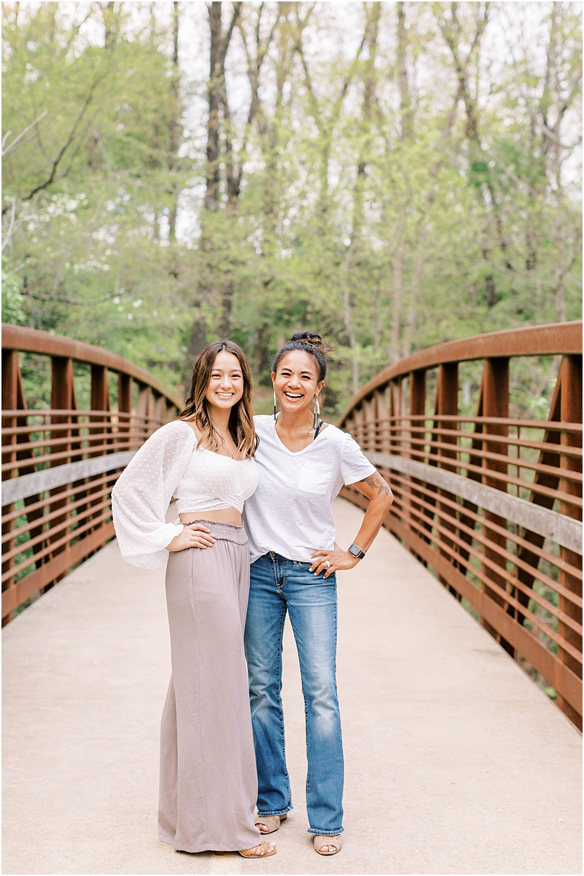 Kaiyah and her mom standing in the middle of a bridge in Arkansas laughing.